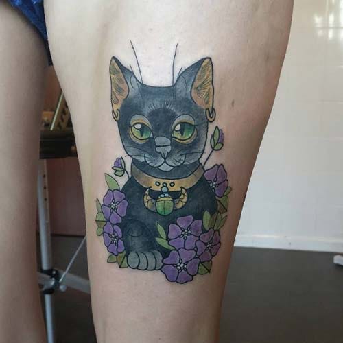 woman thigh cat tattoo