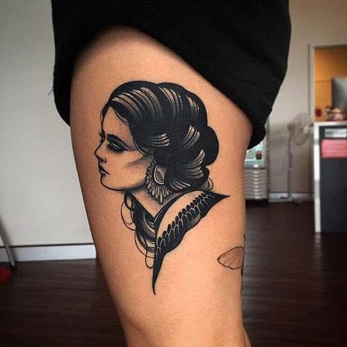 woman thigh portrait tattoo