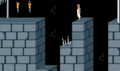 Animated GIF of old-school prince of persia jumping over spikes to hang onto a ledge by his finger tips.