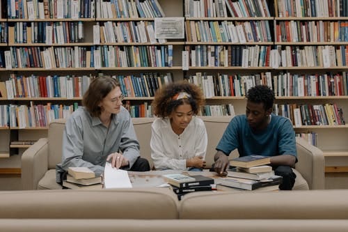 A group of three studying together in a library