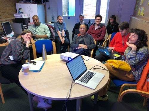 Designers and developers sitting around a table.