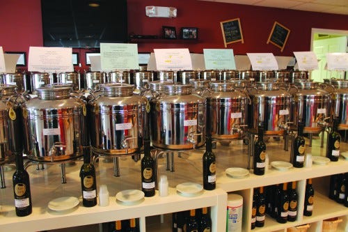 JACK FIRNENO / WIRE PHOTO Olive Lucy stores olive oils and vinegars in metal frusties so visitors can sample the many different flavors. 