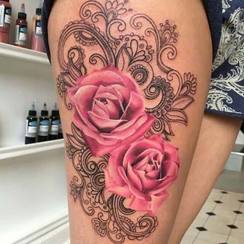 woman thigh pink rose tattoo