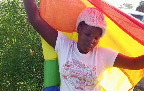 Young black woman with rainbow flag