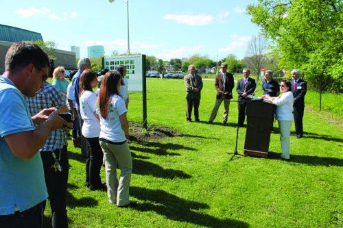 MATT SCHICKLING / WIRE PHOTO Julie Slavet, executive director of the Tookany/Tacony-Frankford (TTF) Watershed Partnership, addresses a crowd during a May 6 ribbon-cutting ceremony. Volunteers have built a riparian buffer along the small creek behind Abington Junior High School.