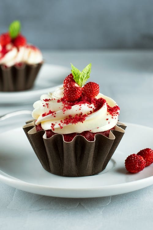 Cupcake with small strawberries.