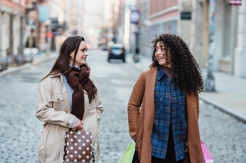 Two close friends walking down the street.