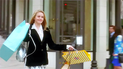 Gif: Cher Horowitz emerges victorious from a little retail therapy.