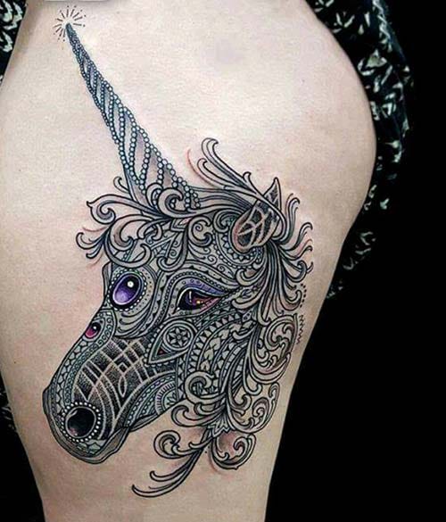 woman thigh unicorn tattoo