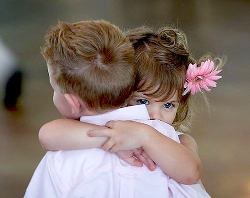 Two children hugging each other