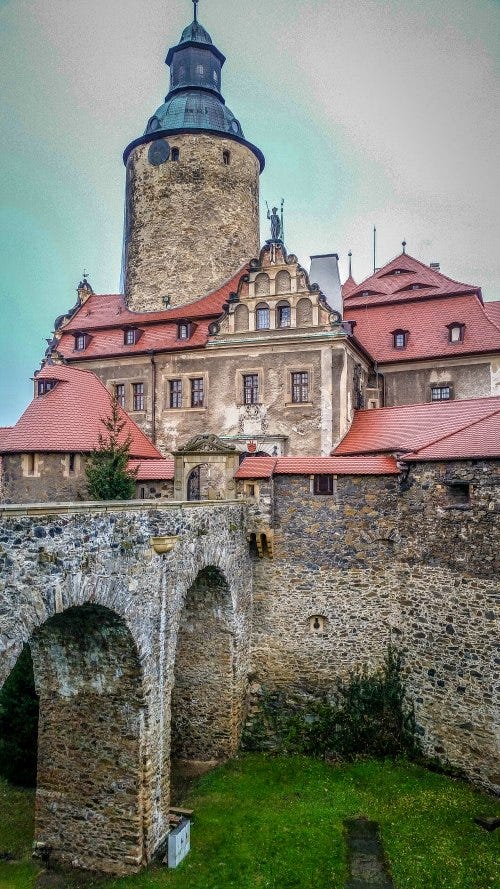 a castle in Poland pictured with a moat