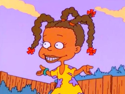 Susie Carmichael from Rugrats, standing in front of a fence with a purple background