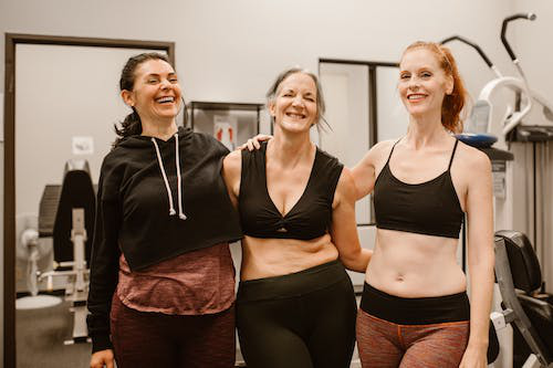 Three women wearing gym wear in a gym