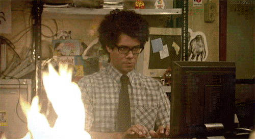 Animated GIF of the scene from IT Crowd with Moss working during a fire.