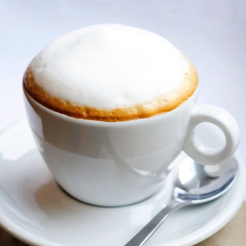 A white cup of Cappuccino Captain Coffee