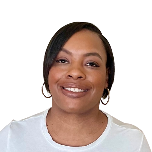 Photo of Lateefah, a Black woman, picture taken from the shoulders up. She is looking at the camera smiling open-lipped. She is wearing a natural colored brown lipstick and black eyeliner with gold hoop earrings in each ear. She has short black hair and is wearing a white t-shirt.