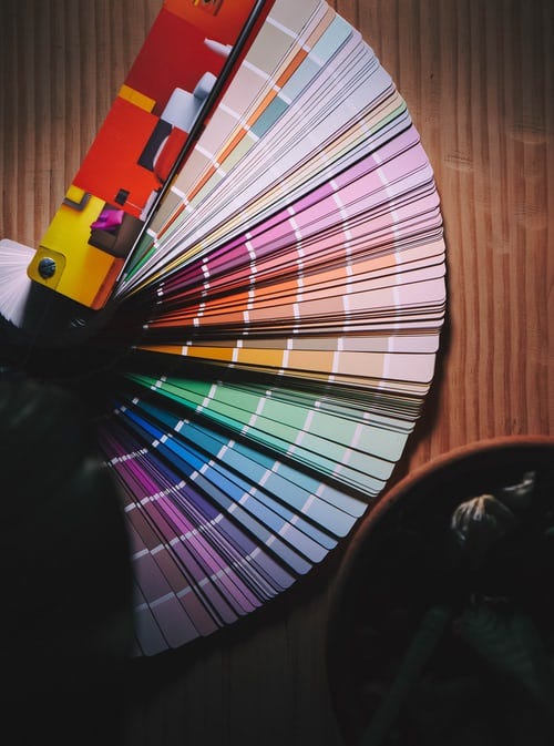 A multi colored umbrella on brown wooden table