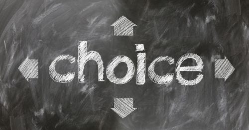 the word “choice” on a blackboard, surrounded by arrows pointing in different directions