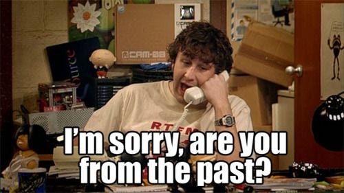 A screenshot from The IT Crowd episode 1, where Roy asks on the phone “I’m sorry, are you from the past?”