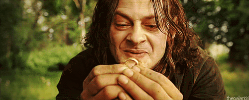 Golum from the lord of the rings, holding up the ring, saying “My Precious”