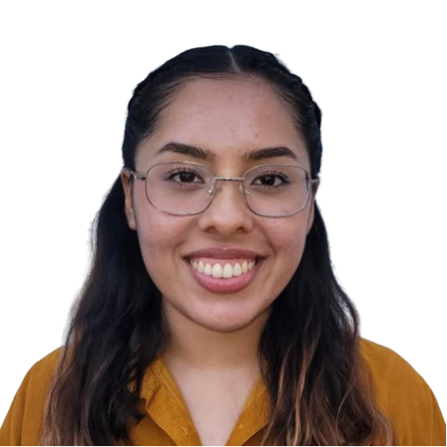 Photo of Gisselle, a young Mexican-American woman of medium complexion, from the shoulders up. She is looking at the camera with an open-lipped smile. She is wearing glasses and an orange collared shirt. Her hair is styled half up, with loose black and bleached hair brushing both shoulders