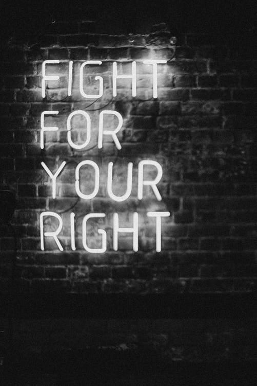 A black and white image of a neon sign saying “Fight for your right.”
