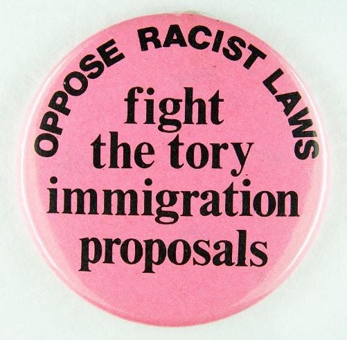 Pink badge which reads, ‘Oppose racist laws: fight the tory immigration proposals’.