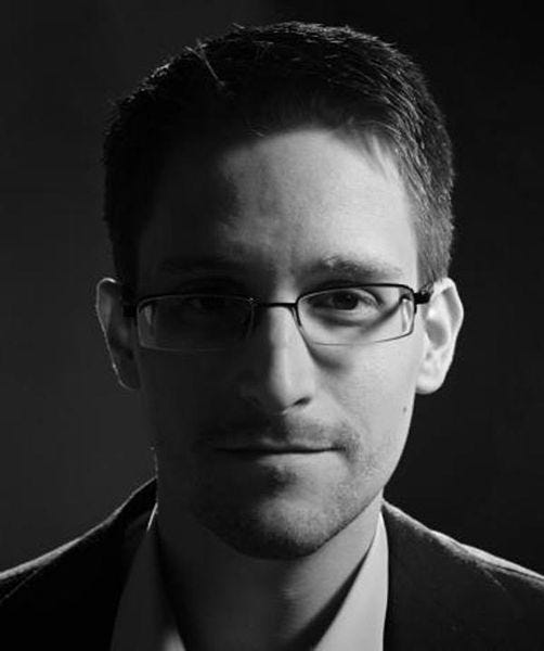 A portrait of Edward Snowden, his face half in shadow.