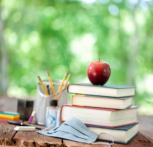 A stack of books with an apple on top