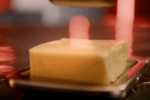 A GIF of a knife gathering butter