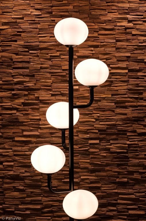 Pendant lights against a textured wall.