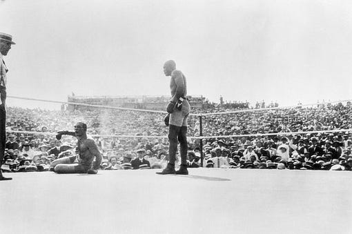 Jack Johnson looms over a fallen Jim Jeffries in the concluding rounds of their Independence Day rumble in 1910.