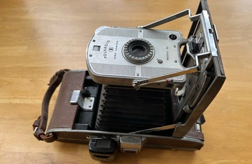 The Polaroid “Land” Camera was the first “instant” camera, but you had to peel your finished photo out of the back.