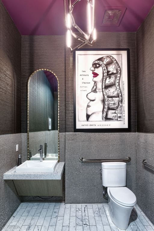 A contemporary bathroom with black, white and chocolate color theme. Graphic art on the wall.