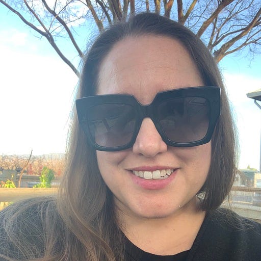 Headshot of Dana Jones with brown hair and black sunglasses.