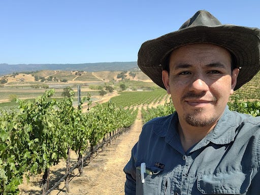 Mituel Garcia posing for a selfie in a vineyard