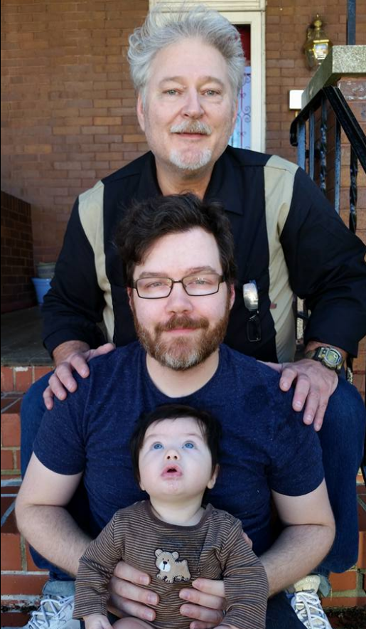 Three generations of Cone boys sit on the stairs of a Baltimore home. My father is behind me. My son is in my lap.