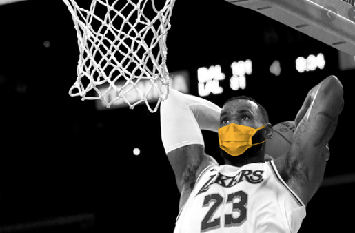 Basketball player (LeBron James) is depicted dunking while wearing mask