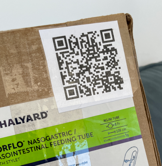 A picture of a QR code taped to a box of nasal gastric tubes