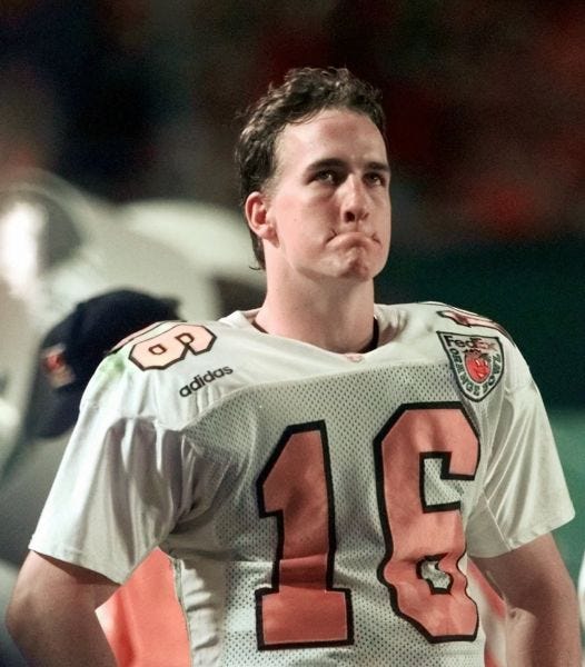 Peyton Manning grimaces on the sideline during a 42-17 loss in the 1998 Orange Bowl.