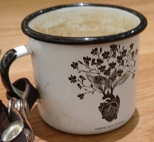 coffee cup with coffee plant rooted in a human heart