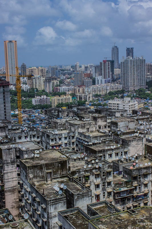 Urban landscape juxtaposition of rich high-rises against poor dwellings.