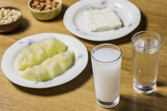 Raki with water, cheese, melon, and nuts