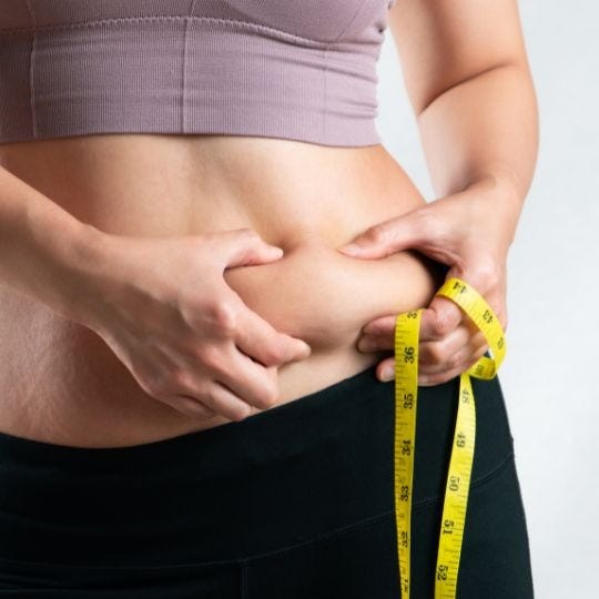 woman checking her abdominal fat