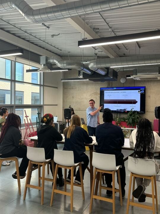 A developer presenting to a group of young women