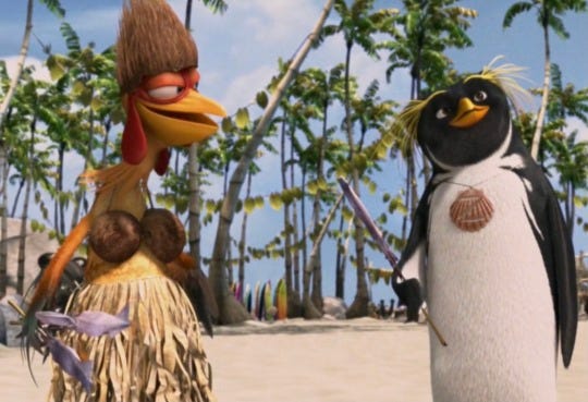 Chicken Joe in coconut shell bra, hat, Luau Hula Skirt talking with Penguin on the beach