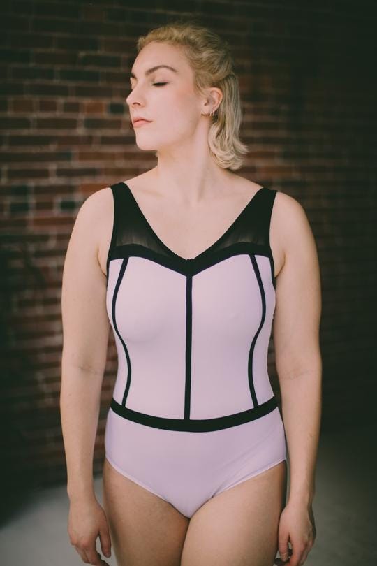 Dancer without the ideal “ballet body” modling a bodysuit