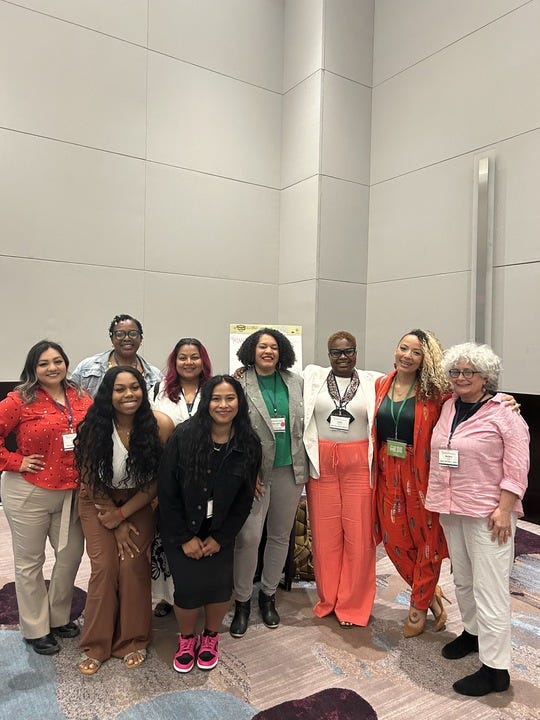 CJSF staff and partners pose for a group picture at the Hewlett Foundation Grantee Convening in 2024. Photo includes 9 women who are Latinx, African American, South Asian, and White spanning ages 18-above their 60's.