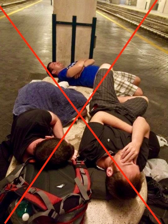 A crossed out photo of three college students sleeping on a bench at a train station