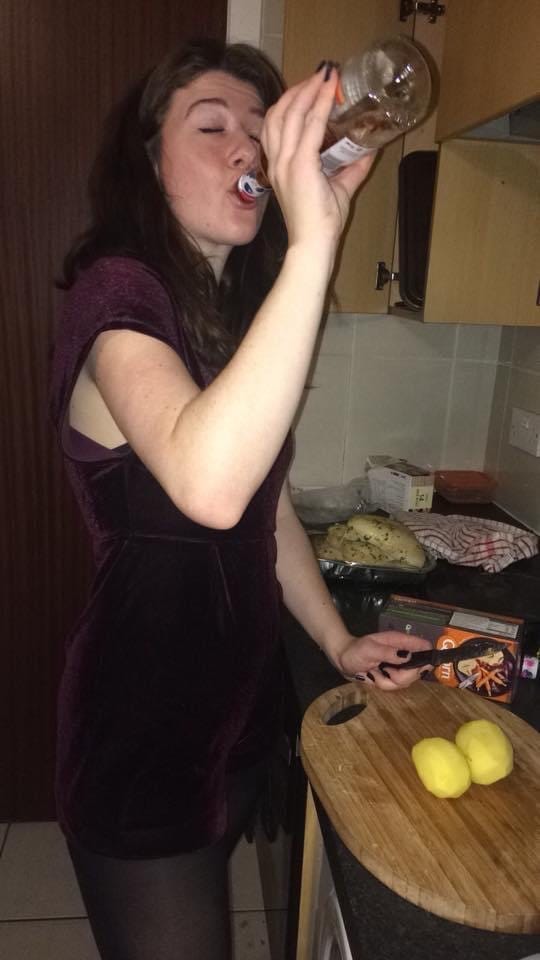 Girl drinking wine chopping potatoes